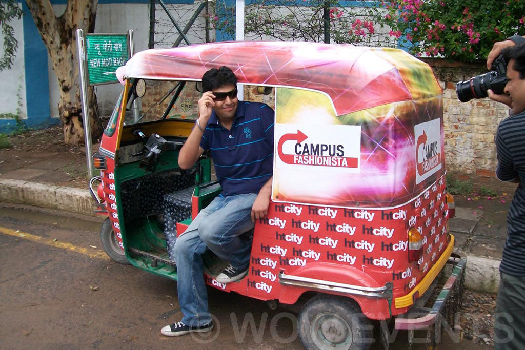 Woman posing in a decorated auto rickshaw