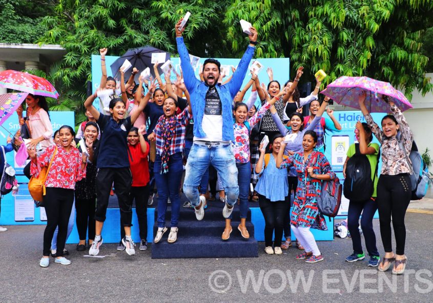 Students cheering at the Haier Smart Laundry campus activation