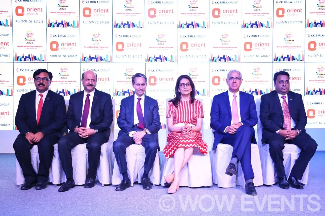 Orient Lighting executives seated on stage
