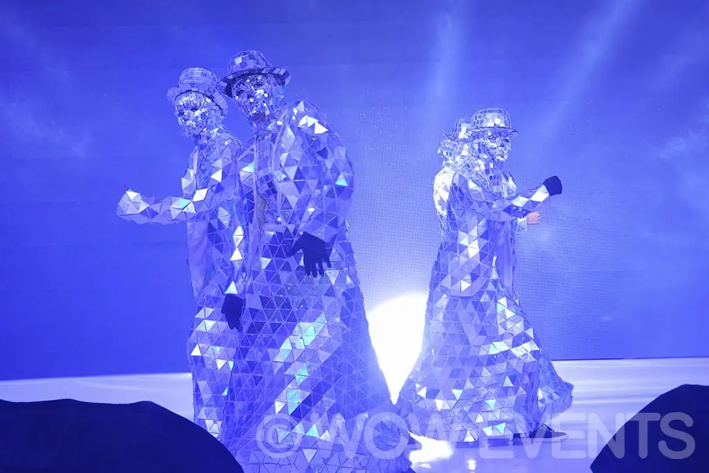 Silver costumed performers on stage
