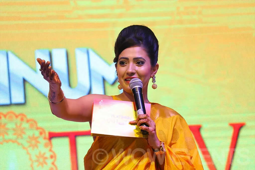 Host in a saree speaking at the Platinum cement launch