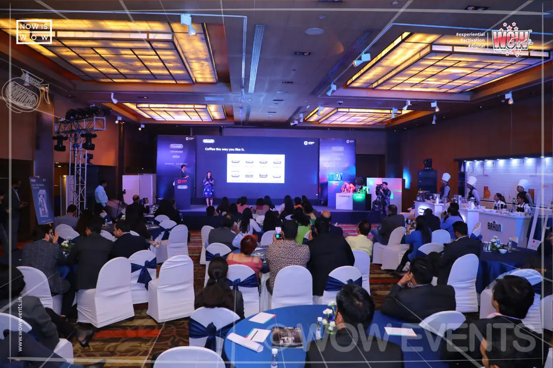 Banquet hall with attendees at the kitchen appliances launch