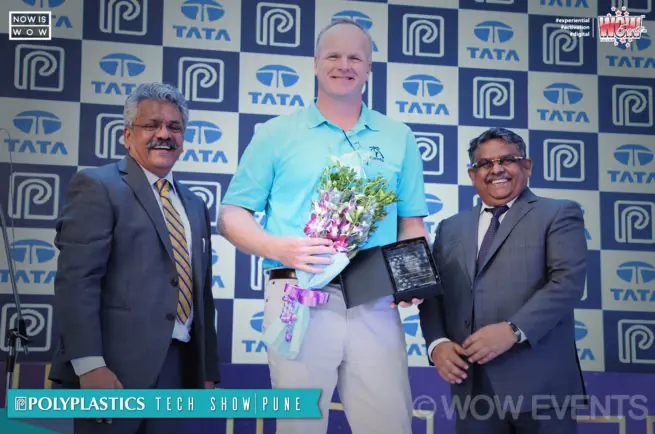 Polyplastics executive receiving a bouquet at the Pune tech show
