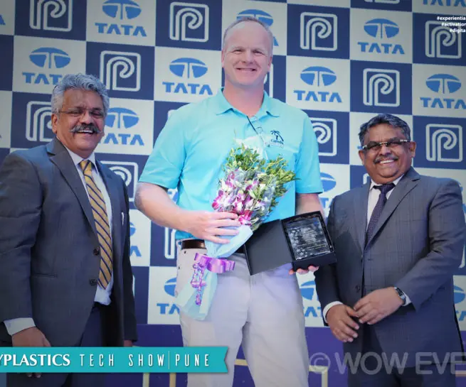 Polyplastics executive receiving a bouquet at the Pune tech show