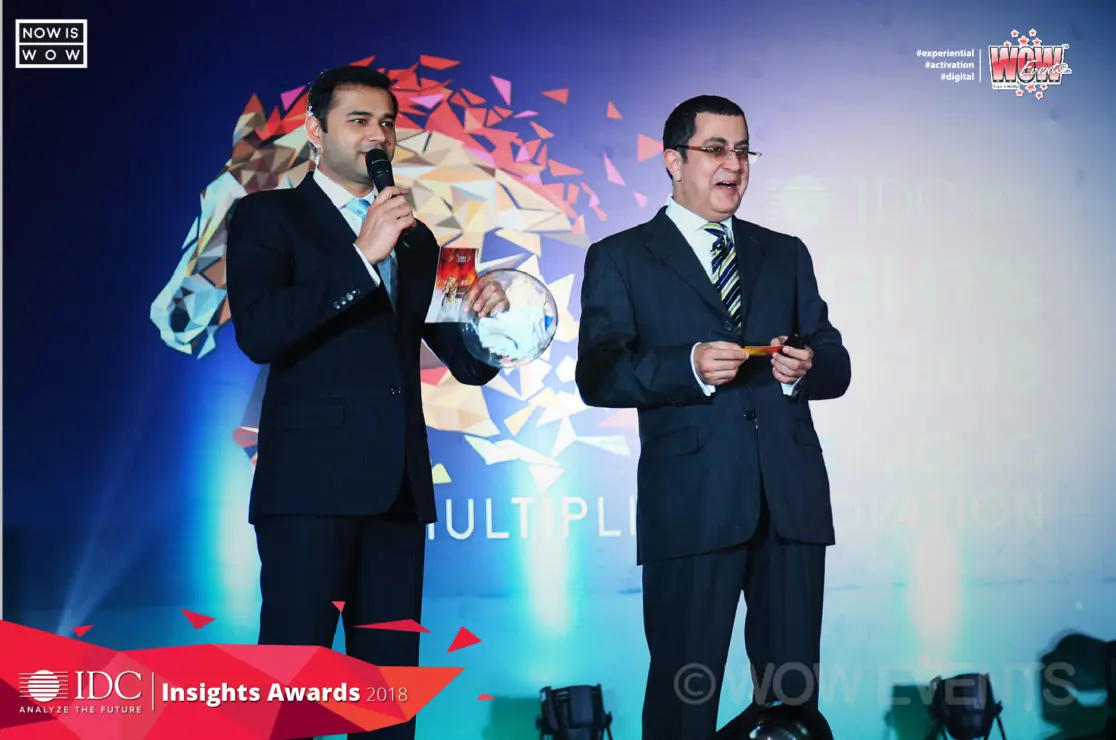 Two hosts on stage at the IDC Insights Awards