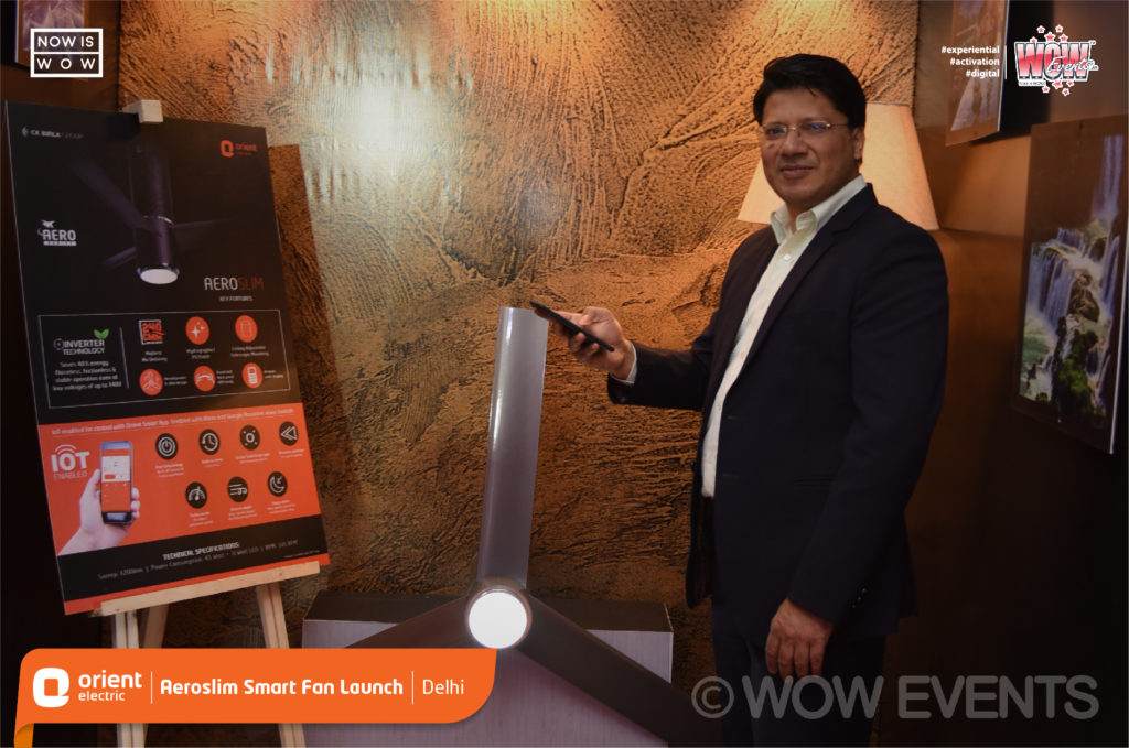Orient executive presenting beside a smart fan display