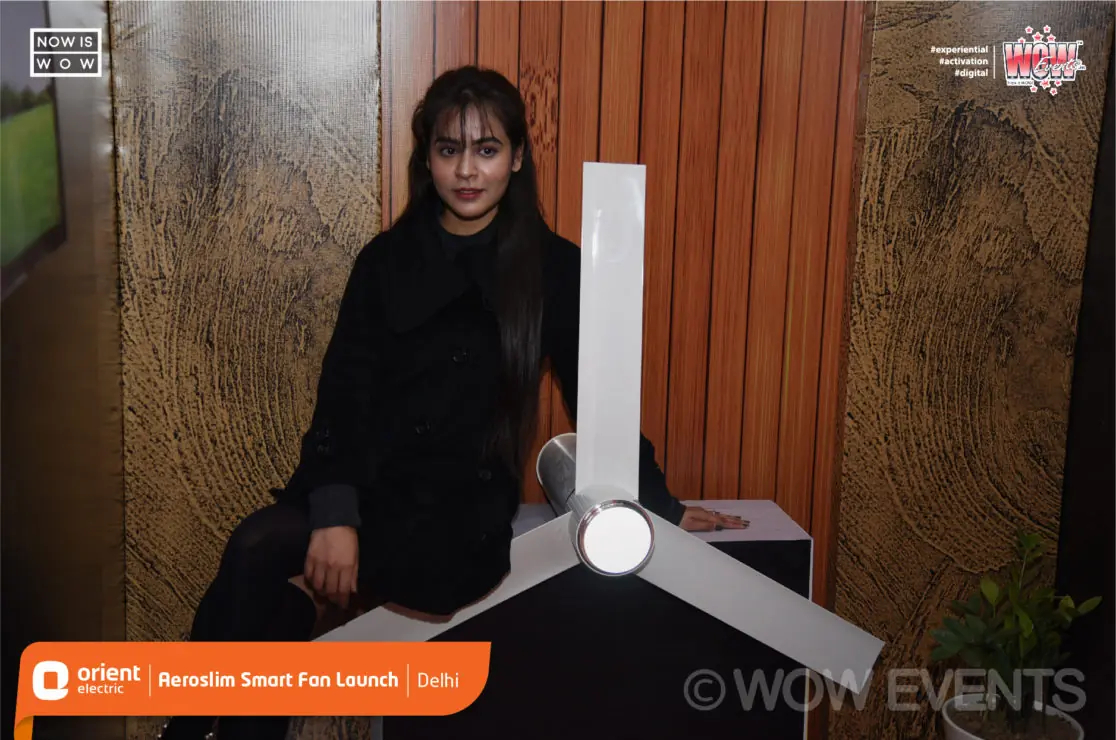 Model posing beside an Orient Aeroslim fan display