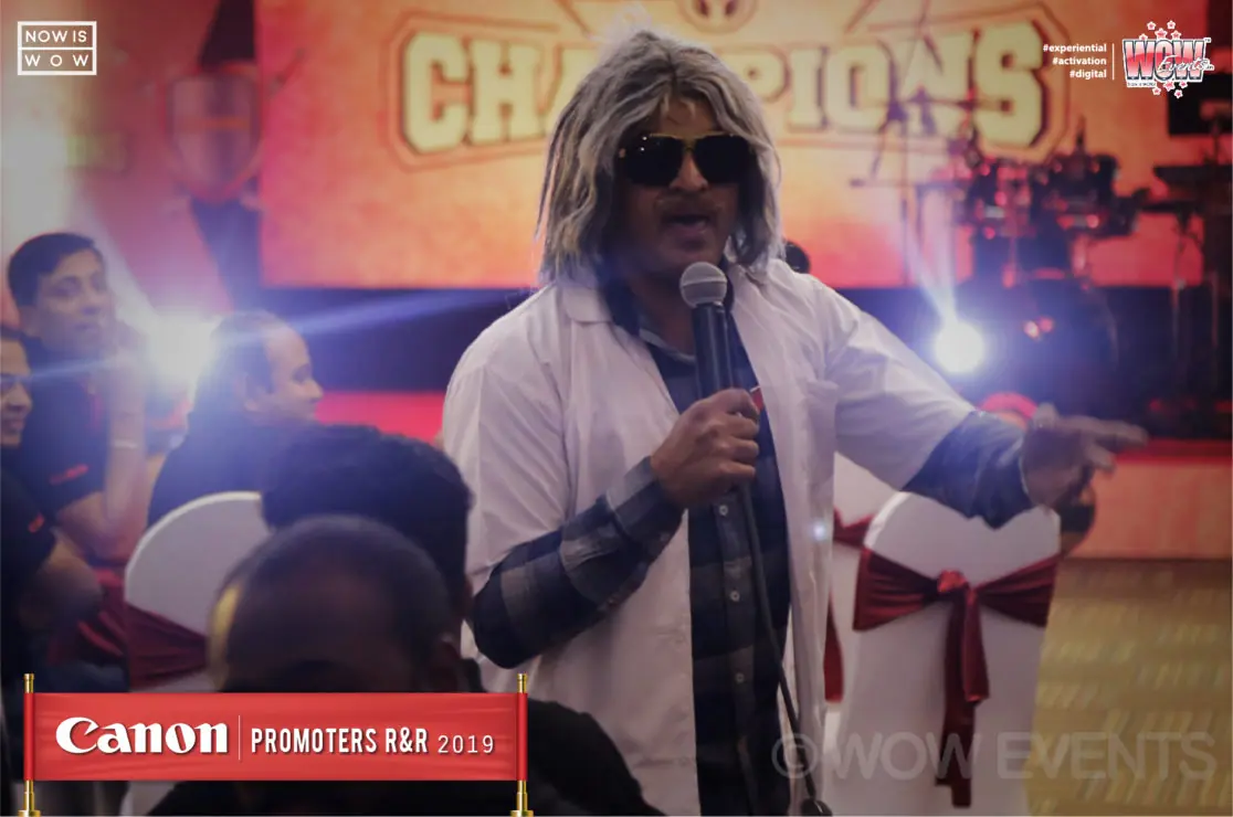 Performer in a white wig on the Canon Champions stage