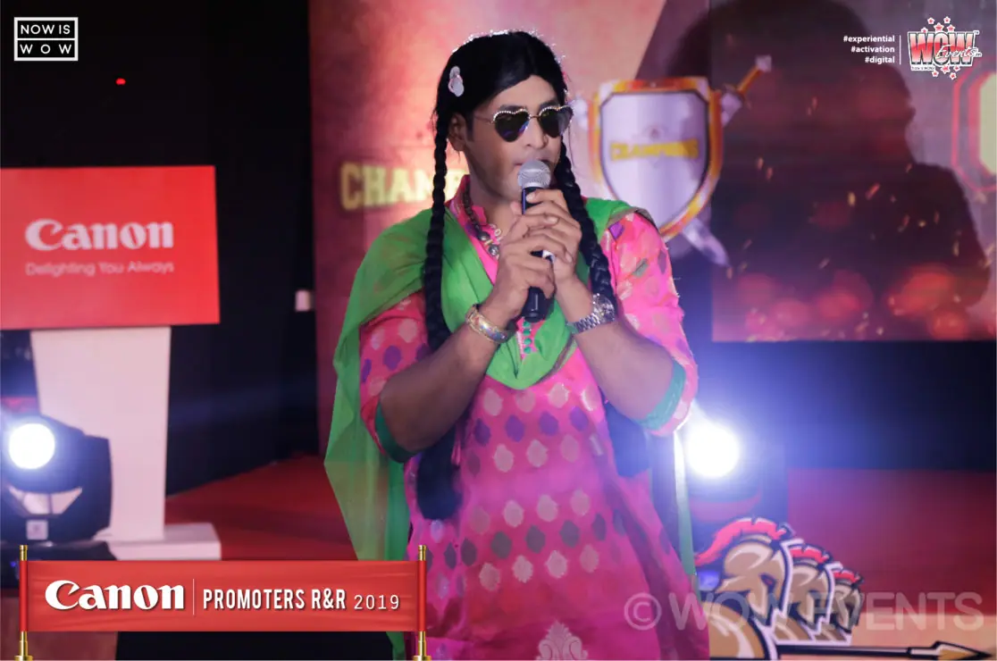 Performer in a colourful costume on the Canon stage