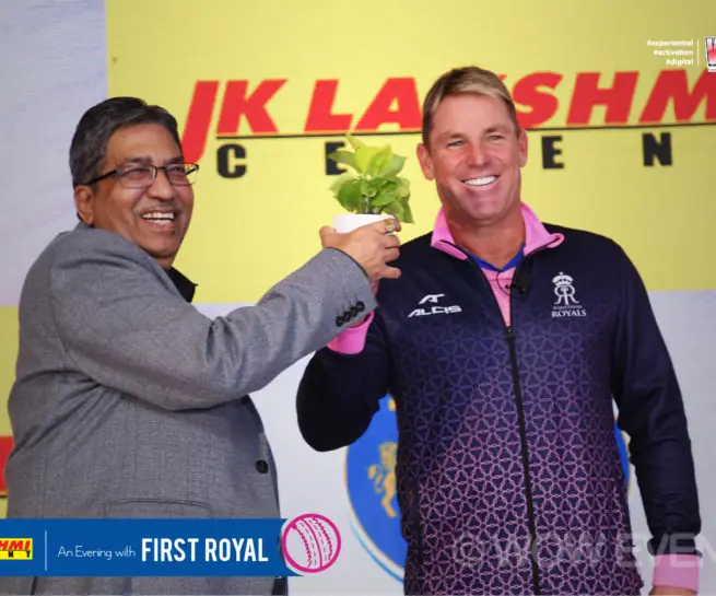 JK Lakshmi Cement executive with Shane Warne on stage