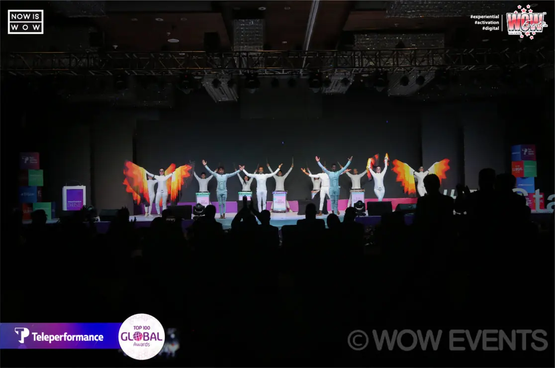 Dancers performing on a dark stage