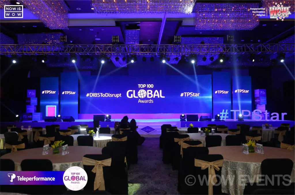 Teleperformance Top 100 Global Awards hall lit in blue