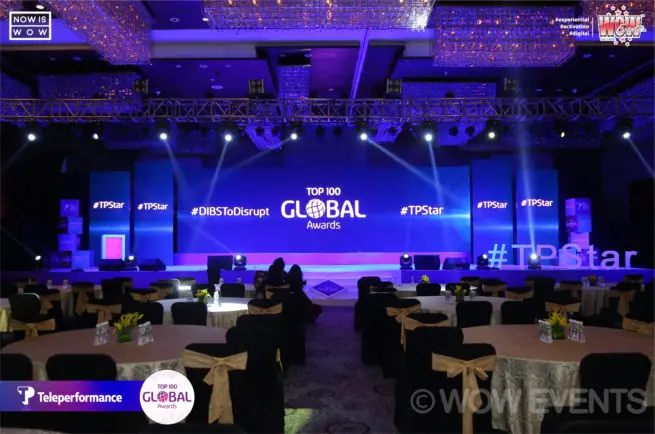 Teleperformance Top 100 Global Awards hall lit in blue