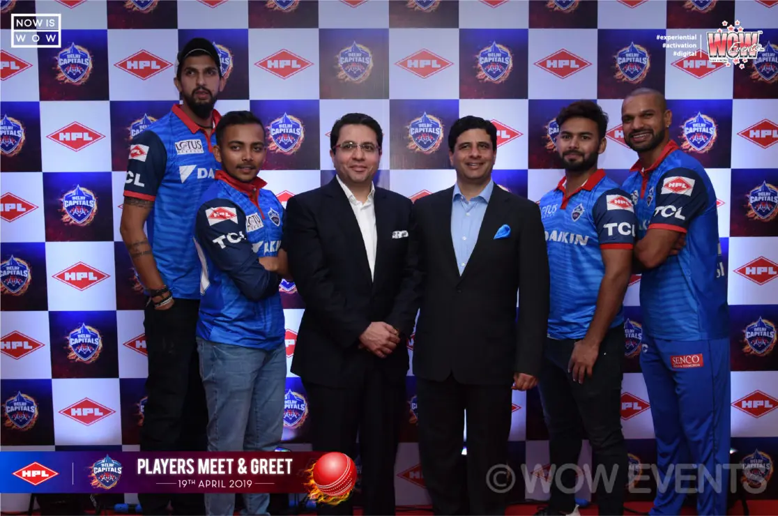 Delhi Capitals players in front of the meet and greet backdrop