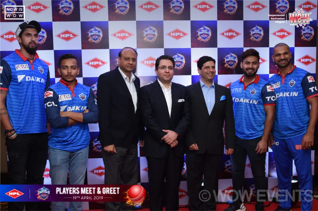 Delhi Capitals players and executives posing on stage