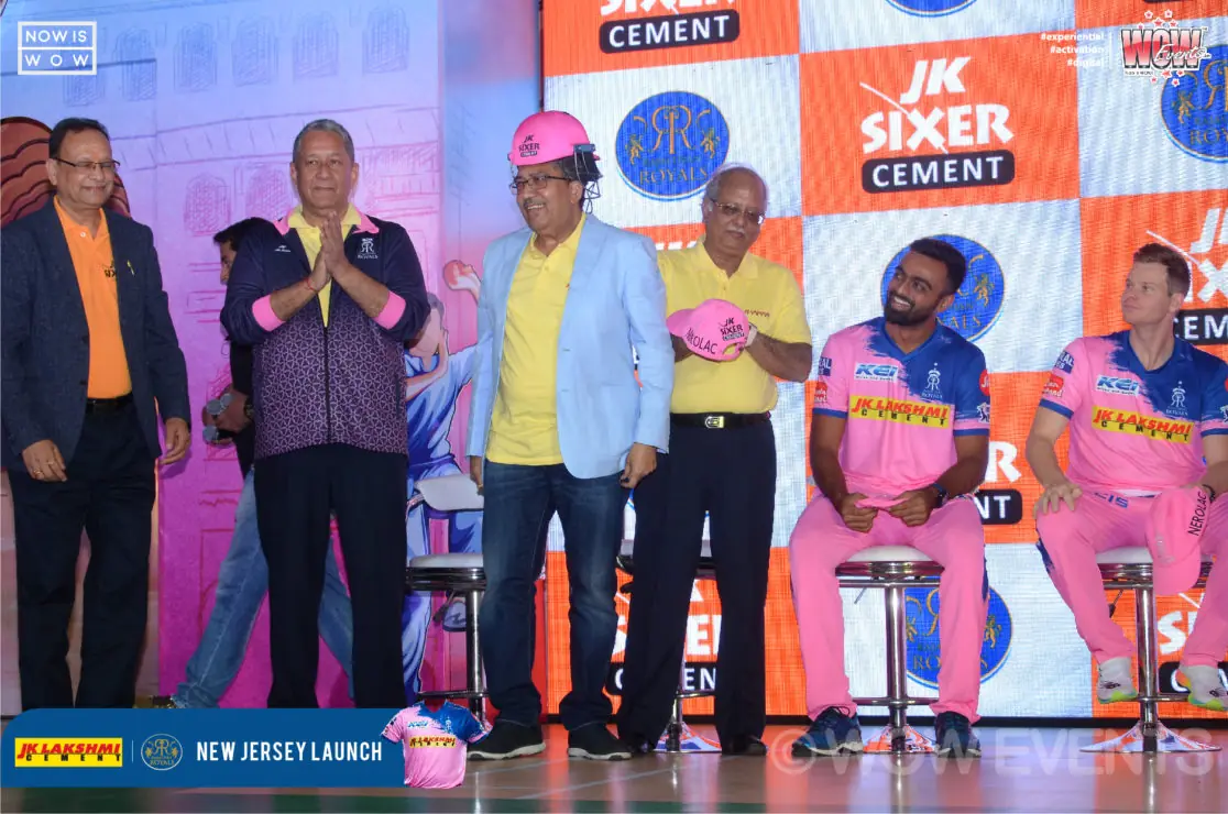 Executives presenting a jersey on stage