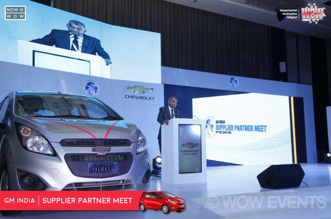 Host and GM executives on stage with a Chevrolet backdrop