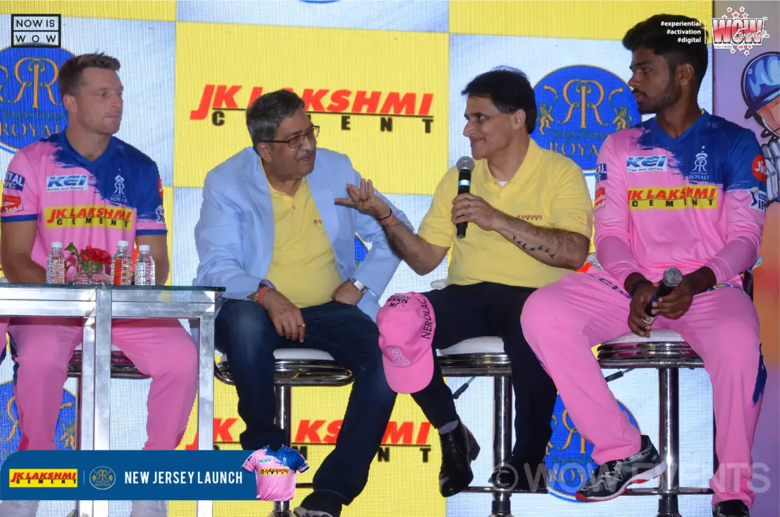 Rajasthan Royals players seated on stage in pink jerseys