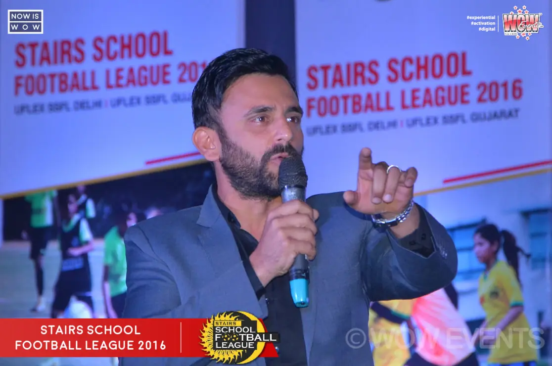 Speaker with a microphone at the Stairs School Football League