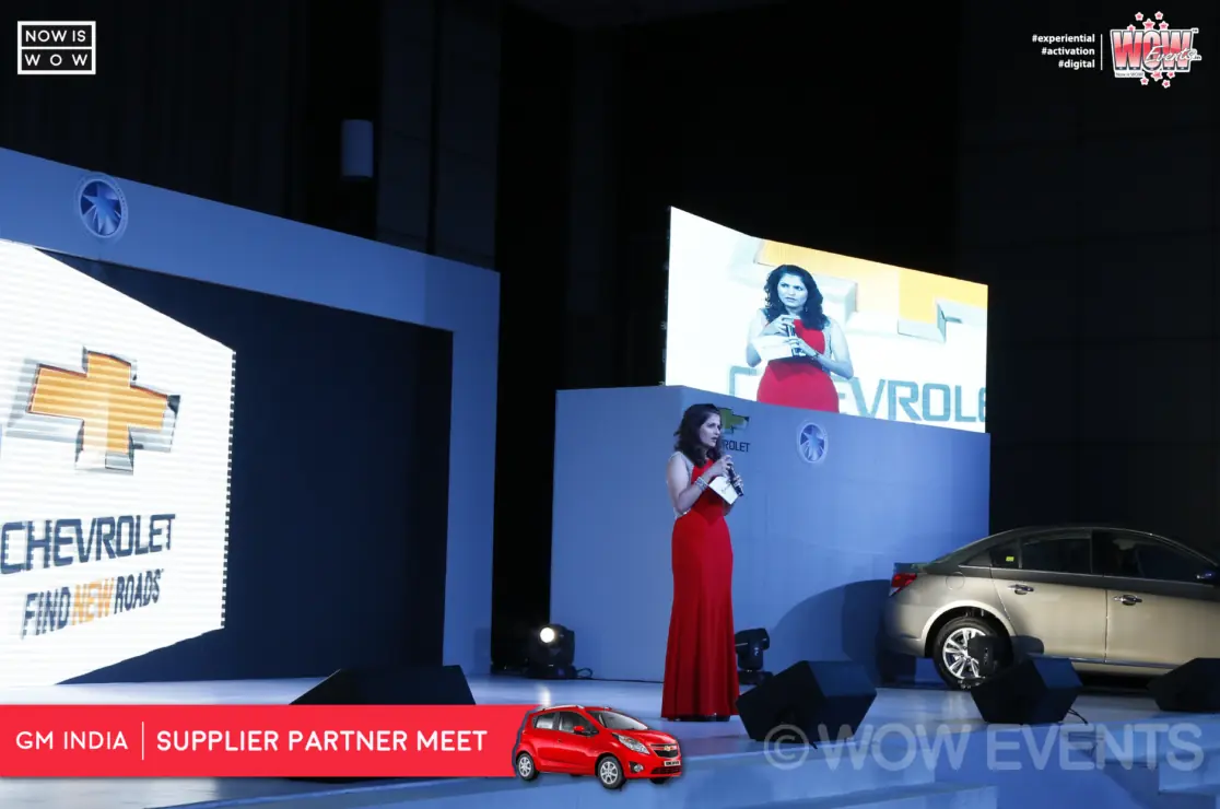 Stage lit with blue beams at the GM India supplier meet