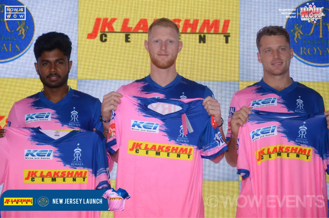 Two players in pink jerseys at the JK Lakshmi Cement backdrop