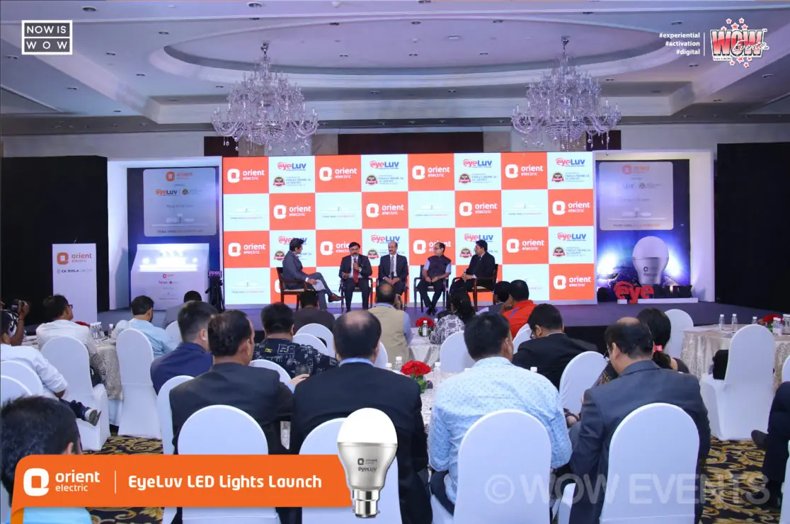 Speaker addressing a seated audience at a corporate event