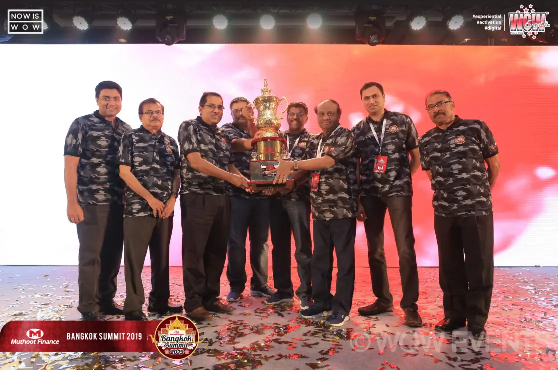 Muthoot Finance team in camouflage shirts with an award