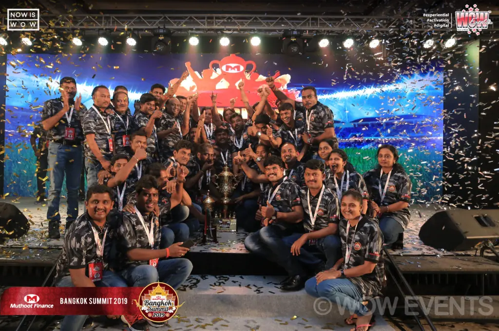 Muthoot Finance team group photo on stage in Bangkok