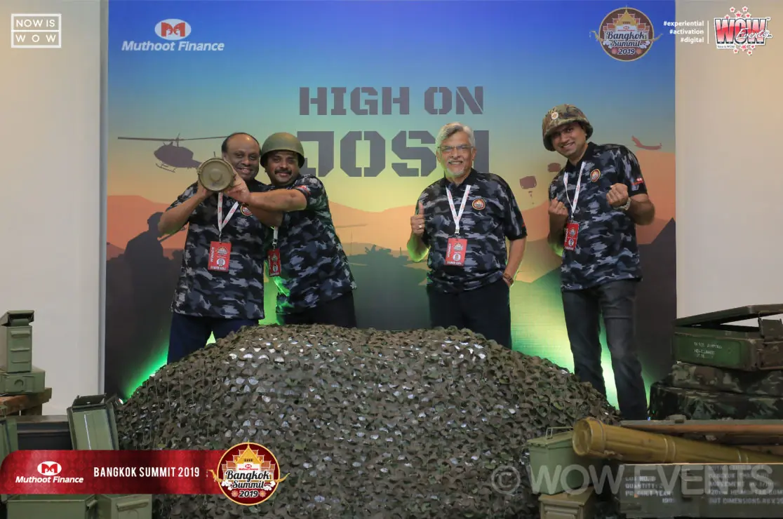 Team posing in front of the High on Josh backdrop