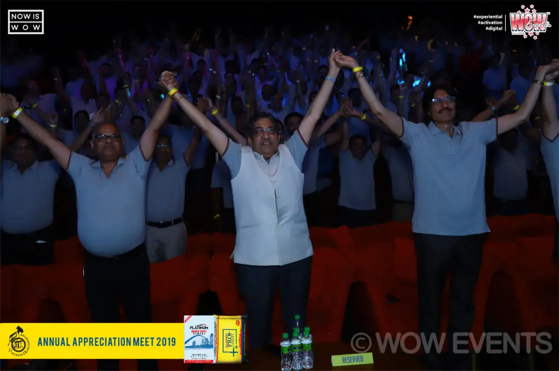 Audience cheering with raised arms at the appreciation meet