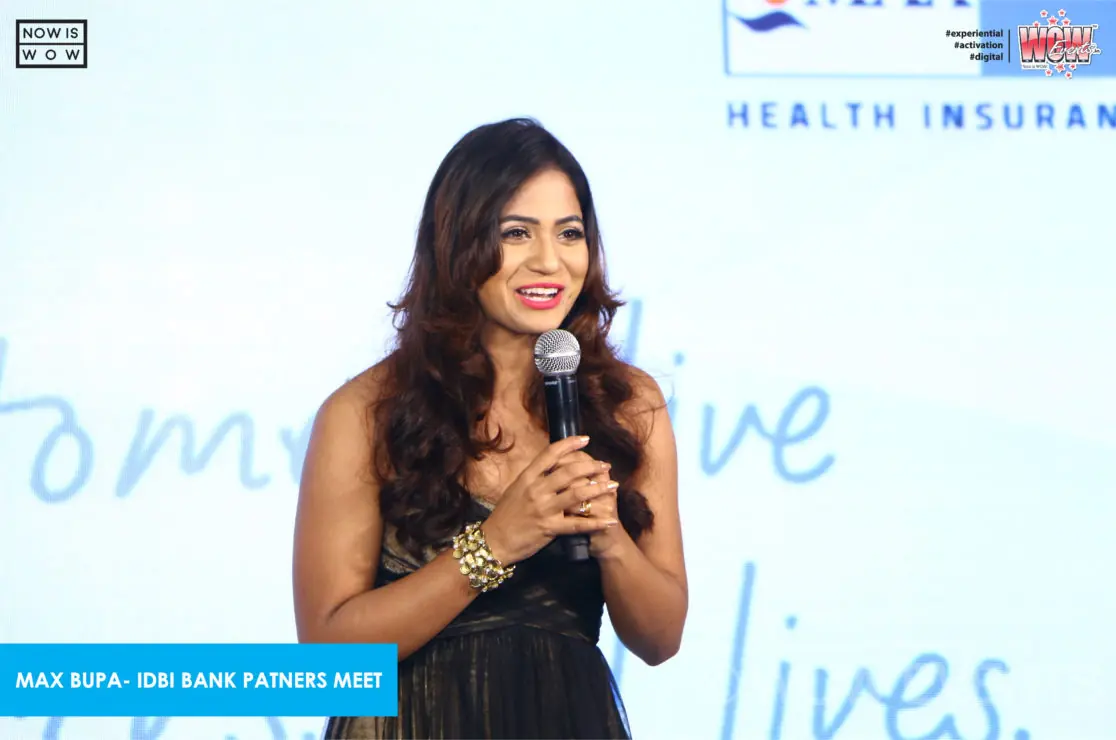 Host speaking on stage at the partners meet