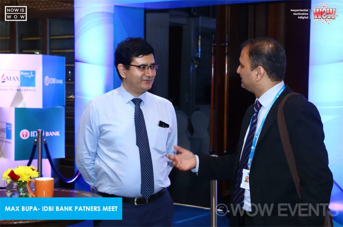 Two executives speaking at the Max Bupa IDBI Bank meet