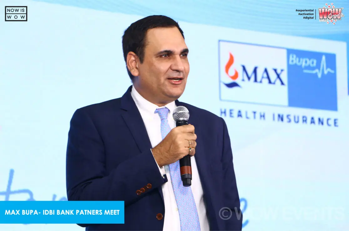 Max Bupa executive speaking with a microphone