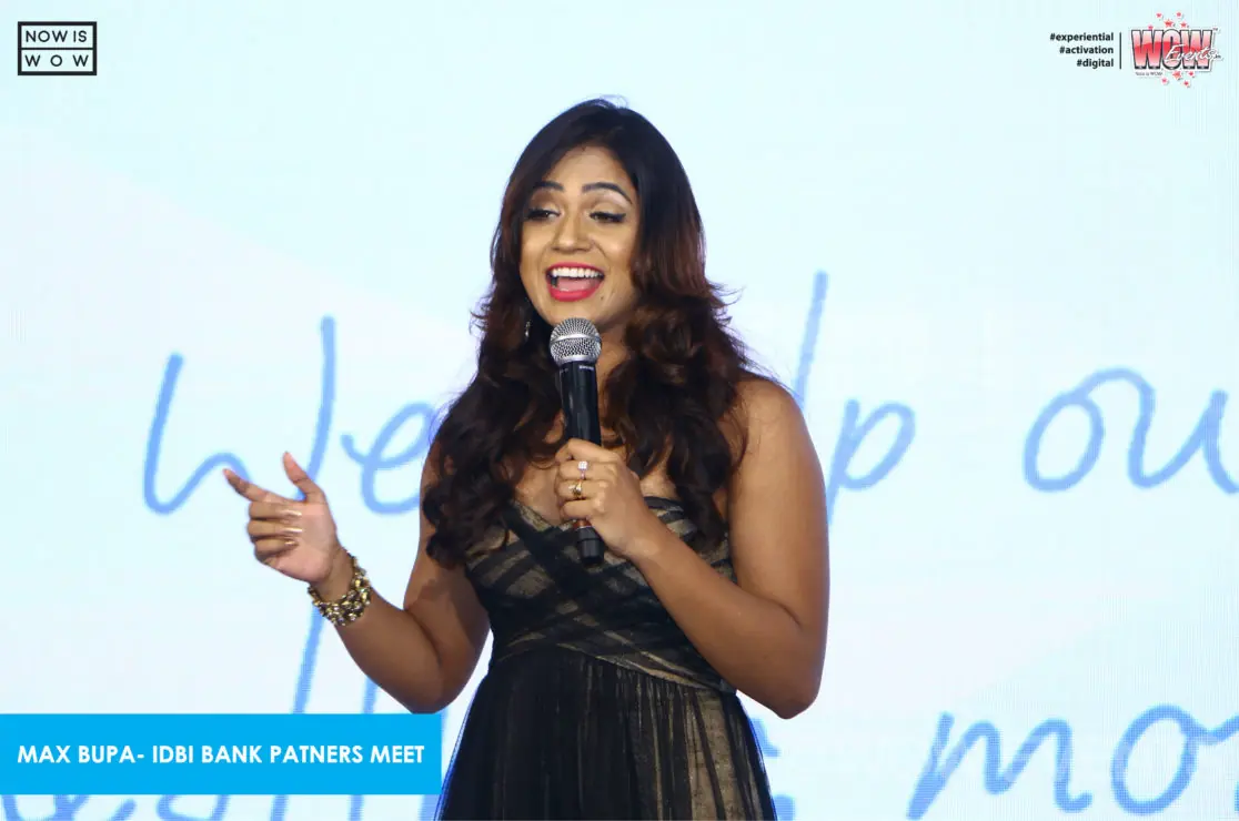 Host with a microphone at the Max Bupa IDBI Bank partners meet