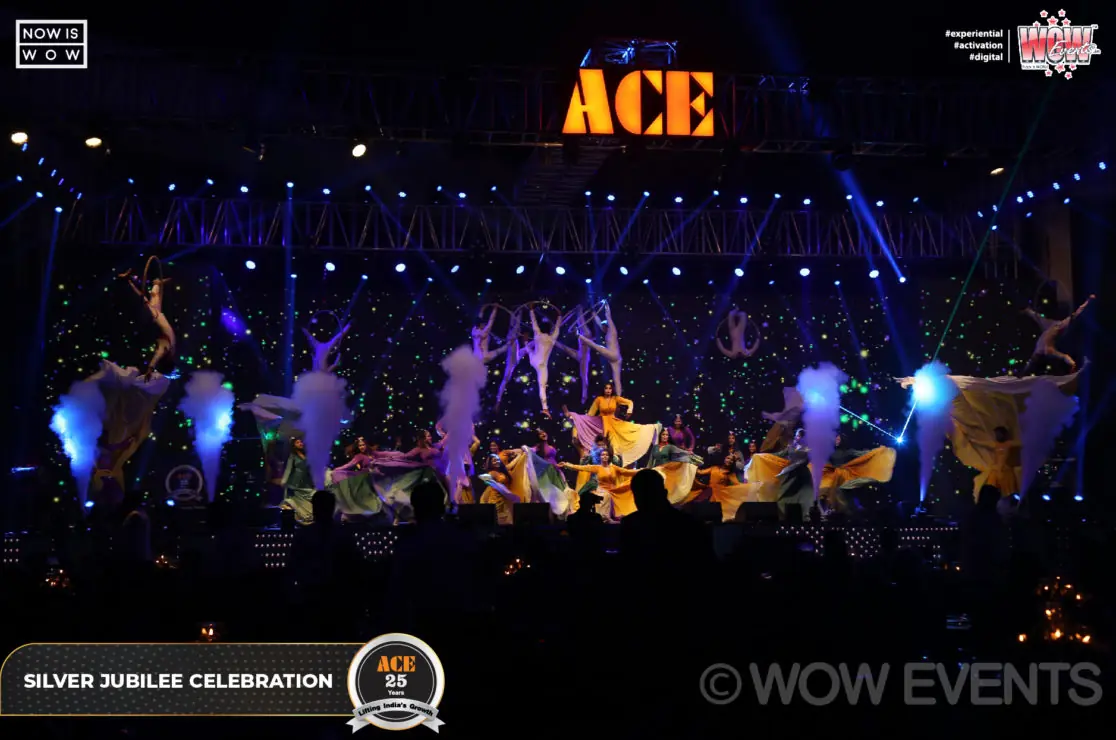Audience watching the stage under the ACE sign at night