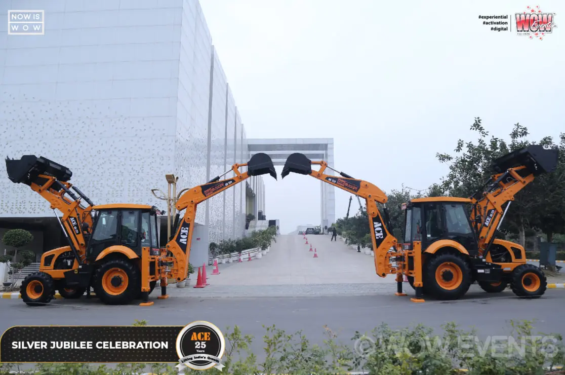 Two yellow backhoe loaders at the ACE silver jubilee celebration