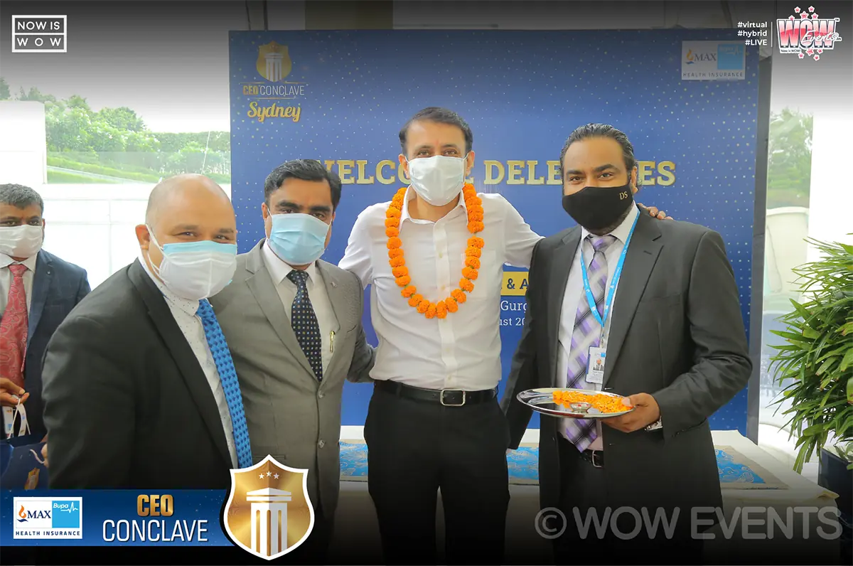 Max Bupa executives with a garlanded guest