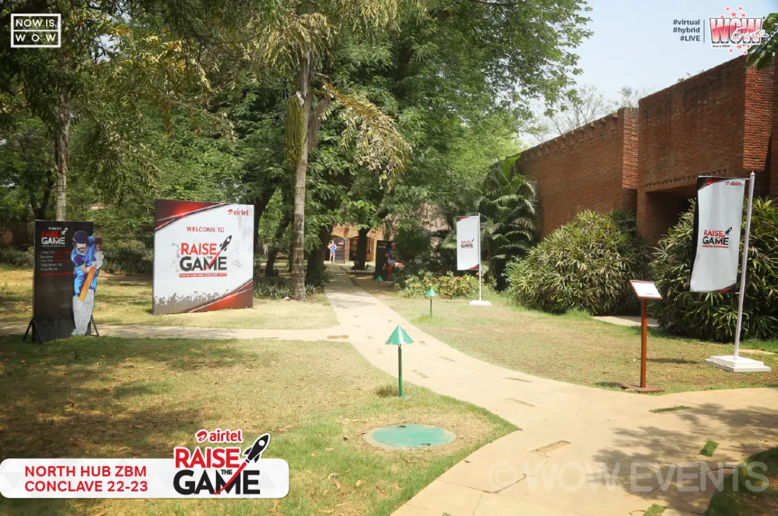 Garden pathway with Raise the Game signs