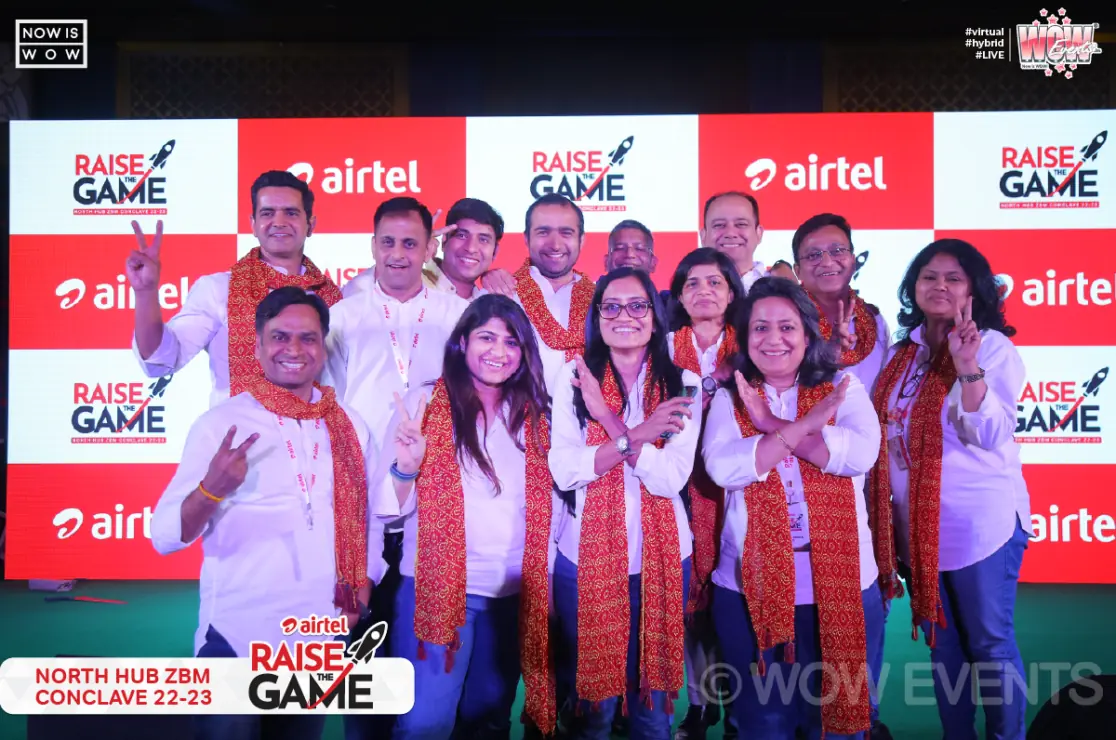 Airtel team posing with the Raise the Game backdrop