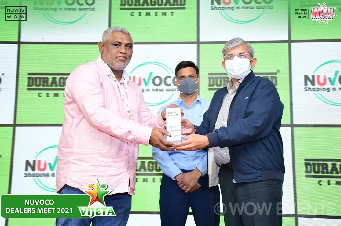 Nuvoco dealer receiving a trophy on stage