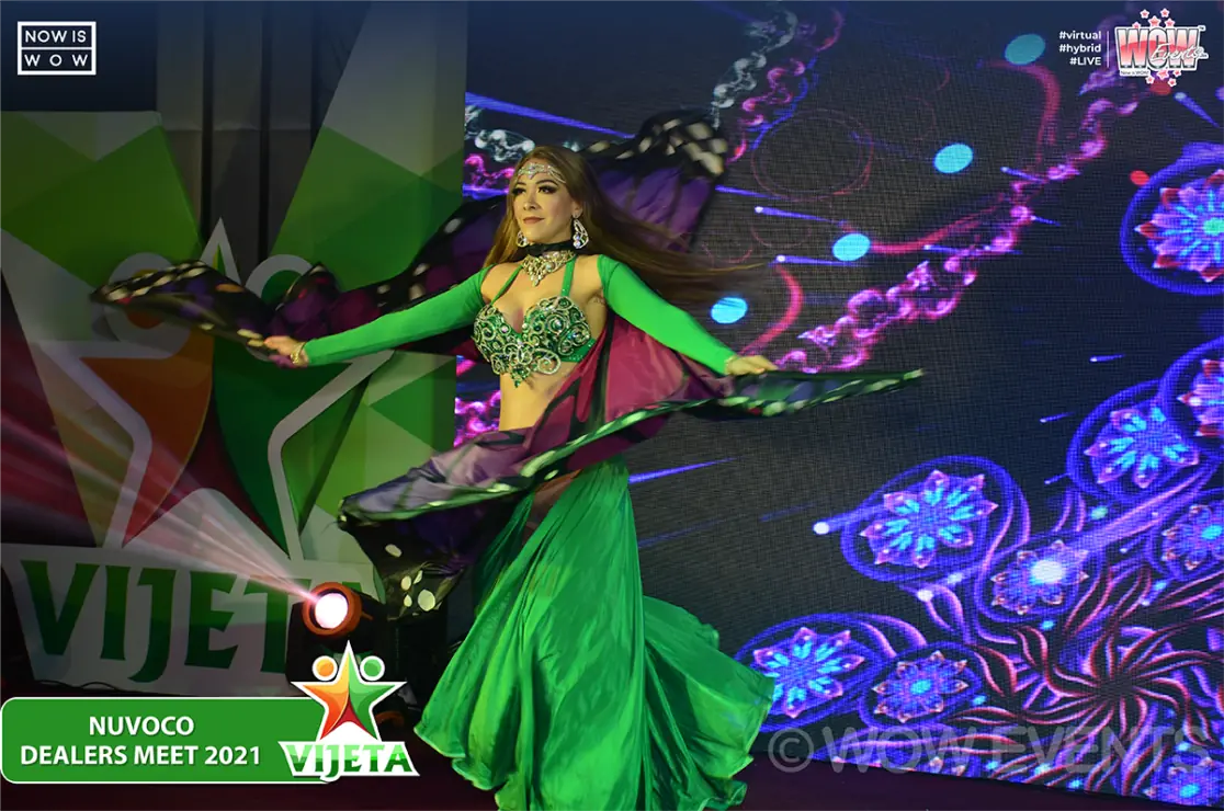 Performer in a green costume on stage