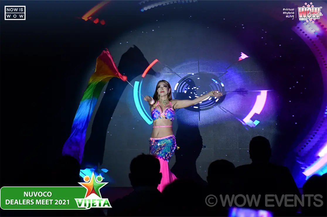 Performer with glowing hoops on a dark stage
