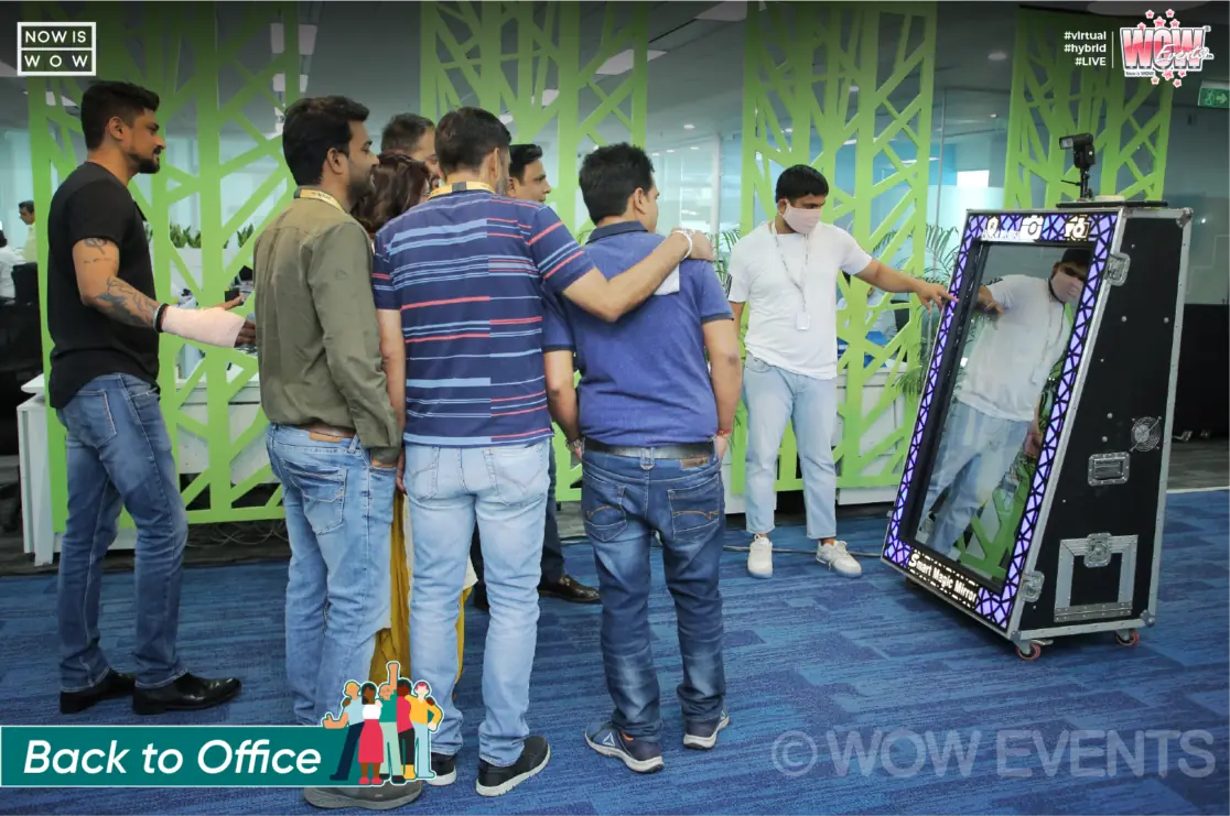 Employees at a photo booth in the Sinch office