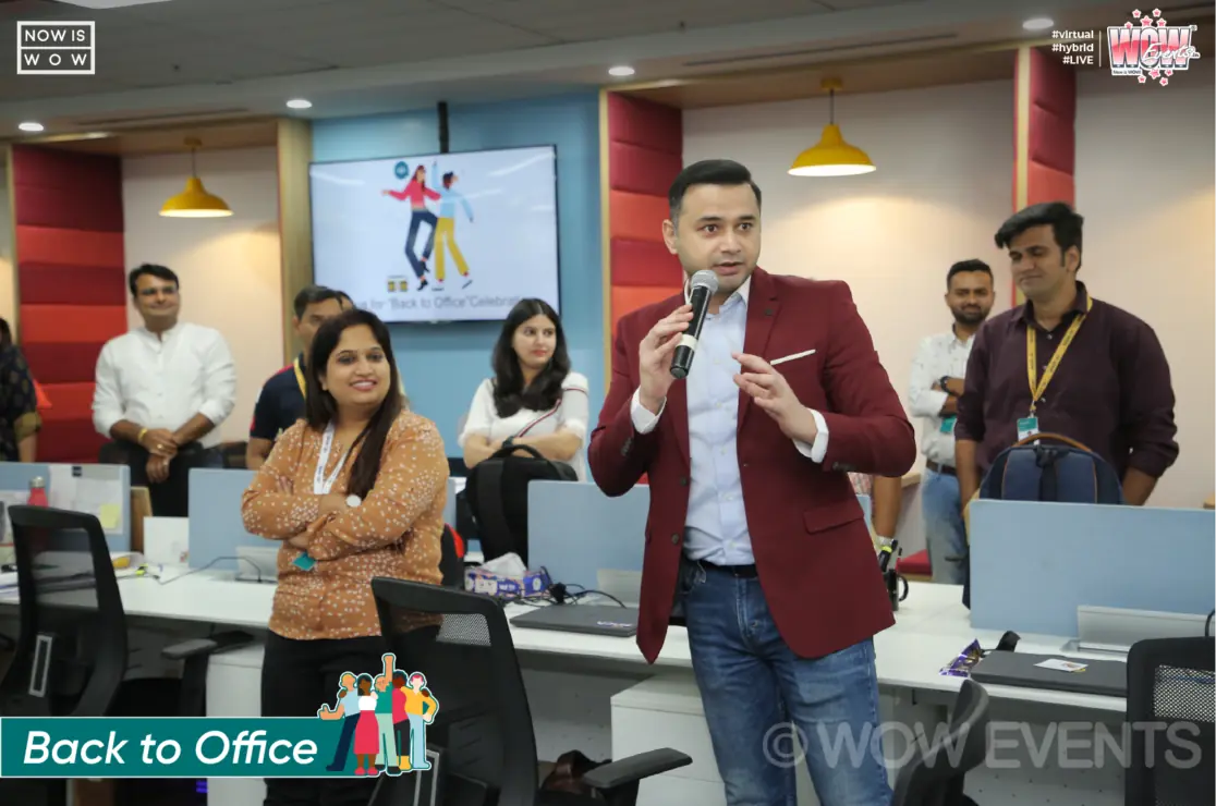 Host with a microphone engaging Sinch employees