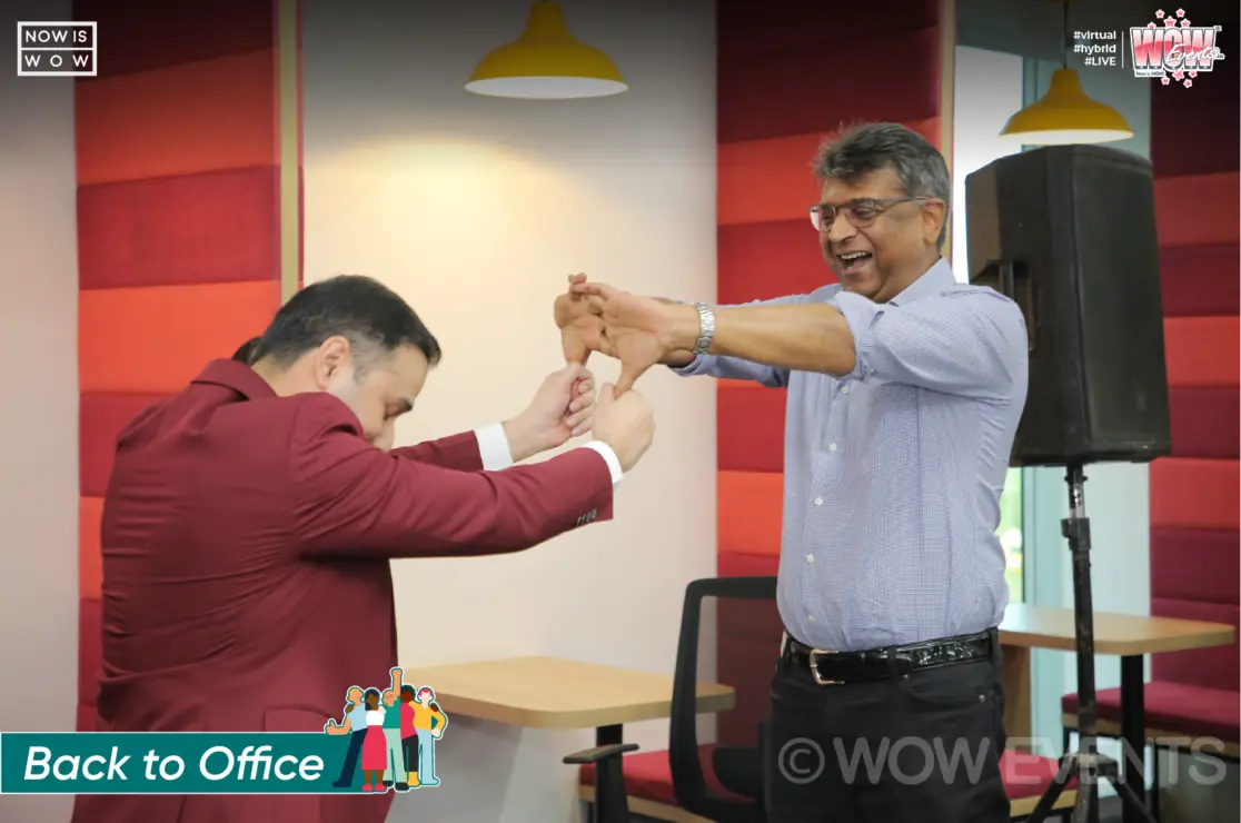 Host and employee playing a game in the office