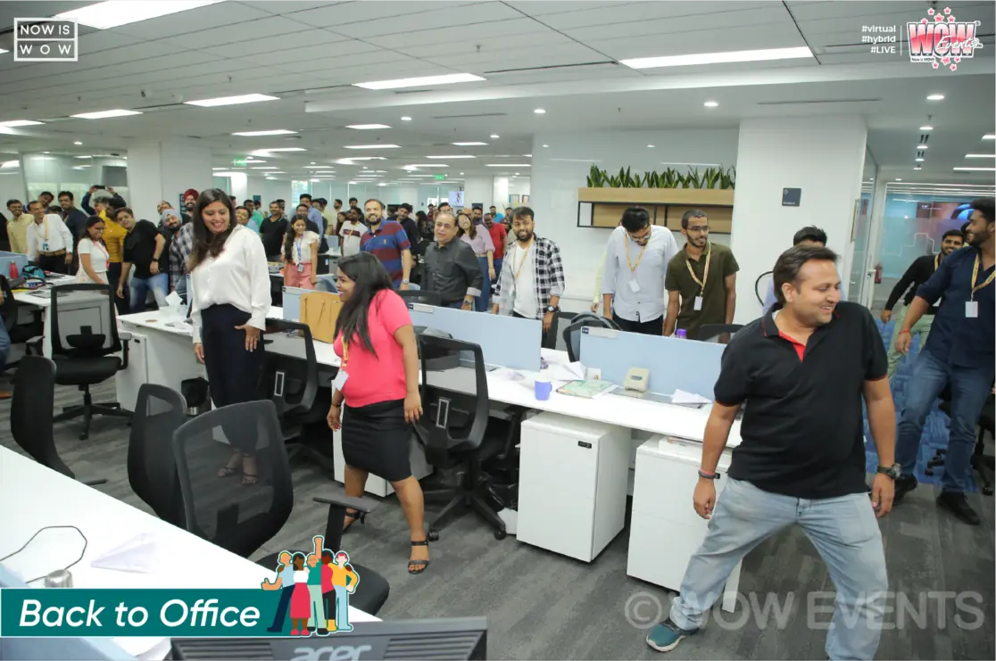 Host walking among employees at the Sinch office event