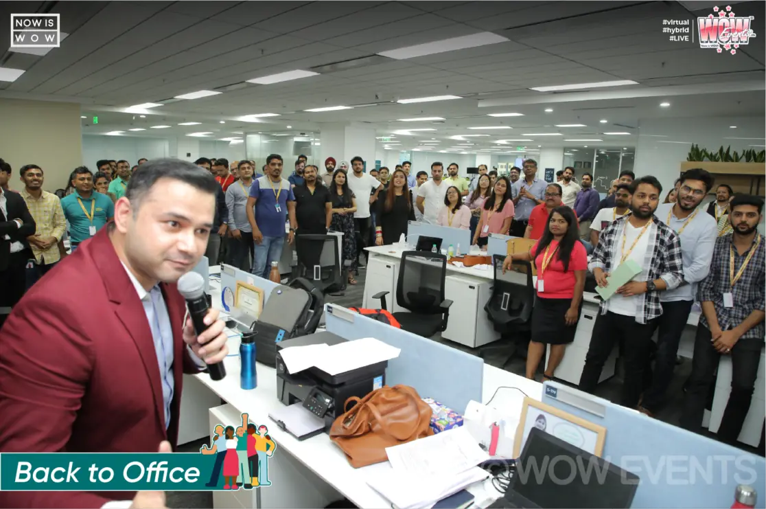 Host with a microphone at the Sinch Back to Office event