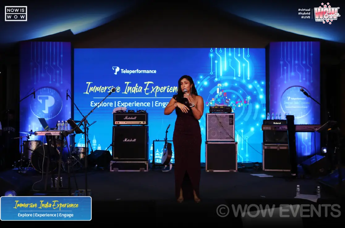 Singer performing on a blue-lit stage