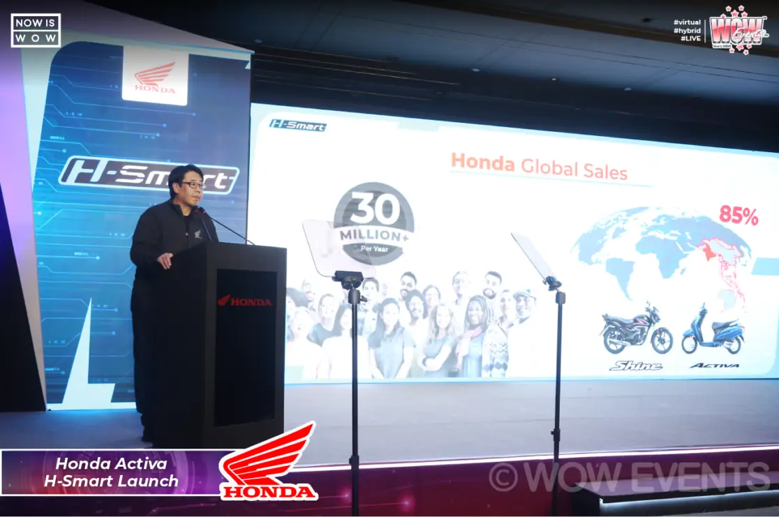 Honda executive presenting global sales on stage