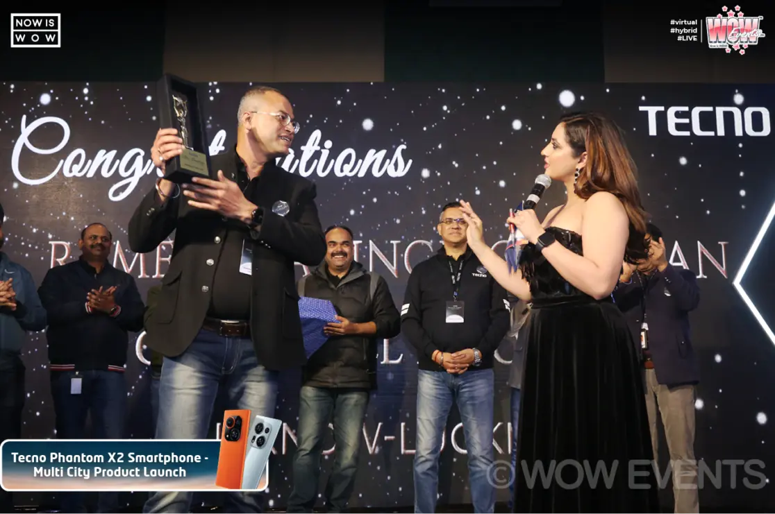Host congratulating a Tecno partner on stage